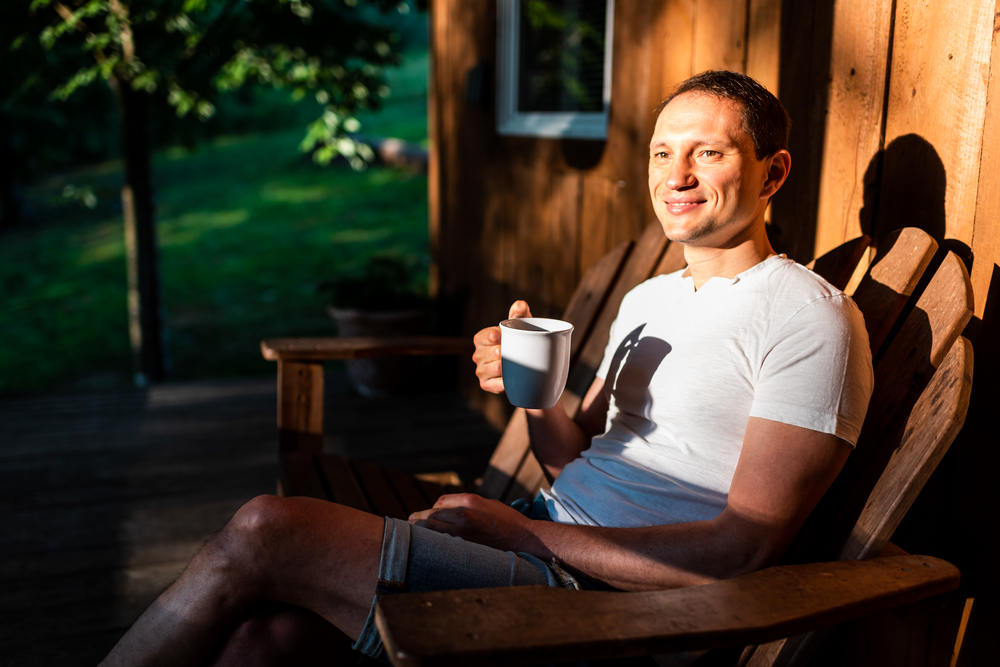 Dad Monitoring His Kids Playing on his backyard deck